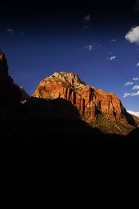 Scenic view of mountain against blue sky