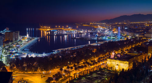 Malaga city with seafront and harbor in the night, costa del sol, malaga province, andalucia, spain