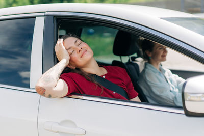 Portrait of young woman in car