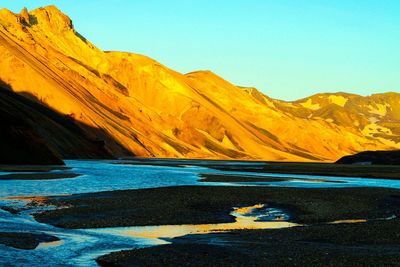 Scenic view of mountains against clear blue sky