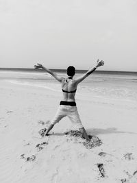 Man standing on beach against clear sky