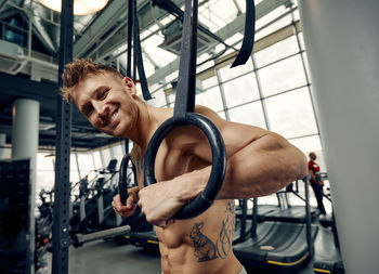 Portrait of muscular man exercising at gym