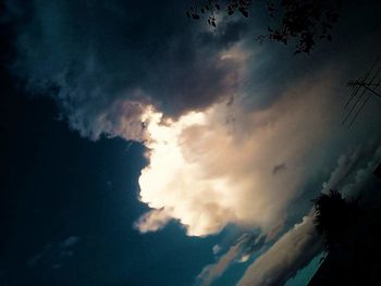 Low angle view of silhouette trees against sky