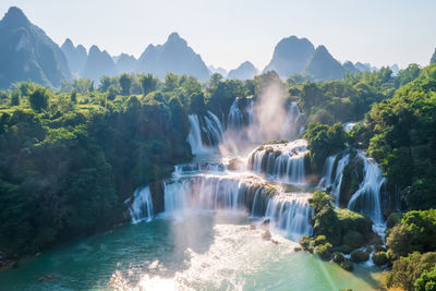 Scenic view of waterfall against sky