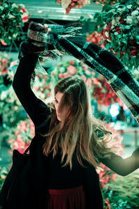 Young woman with long hair holding scarf