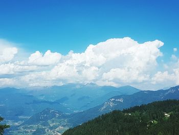 Scenic view of mountains against blue sky