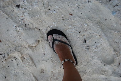 Low section of person standing on tiled floor