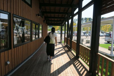 Rear view of woman standing in corridor