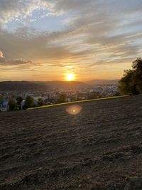 Scenic view of field against sky during sunset