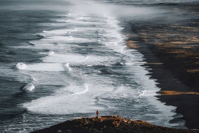 Mid distance of man standing at beach