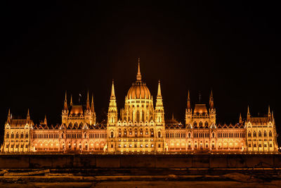 Illuminated hungarian parliament building against sky at night