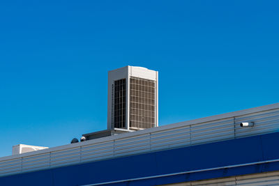 Low angle view of building against clear blue sky