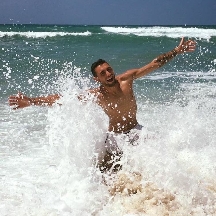 MAN SURFING ON SEA