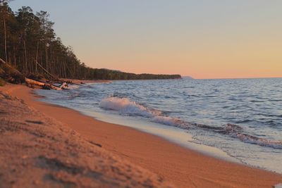 Scenic view of beach against sky during sunset