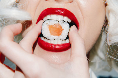 Cropped image of woman with red flower