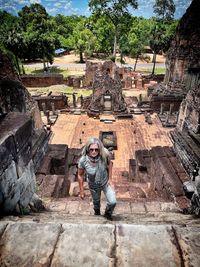 Rear view of man standing on rock