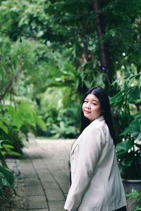 Portrait of a smiling young woman standing outdoors