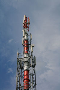 Low angle view of communications tower against sky