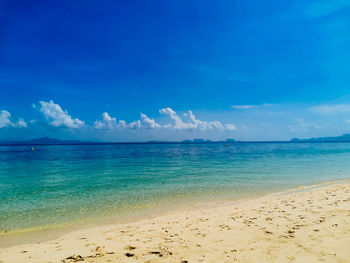 Scenic view of sea against blue sky