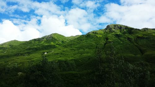 Scenic view of mountains against cloudy sky