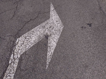 High angle view of arrow sign on road