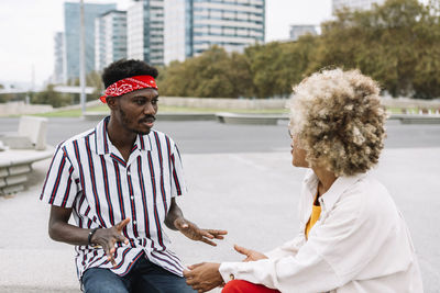 Portrait of smiling friends standing against trees