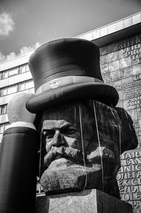 Low angle view of text on pole against sky