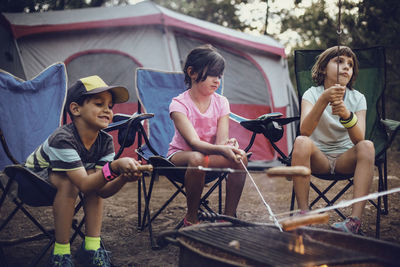 Siblings barbecuing in forest