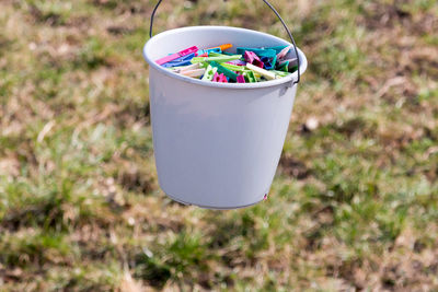 Bucket of colorful clothespins