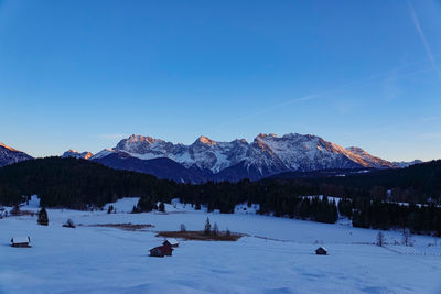 Scenic view of snowcapped mountains against clear blue sky