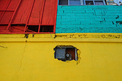 Low angle view of yellow mounted on wall