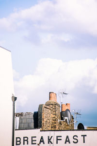 Low angle view of building against sky with the word breakfast on it.