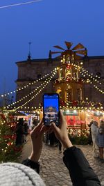Low section of woman using mobile phone at night