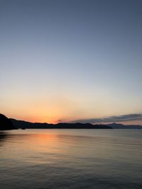 Scenic view of sea against clear sky during sunset