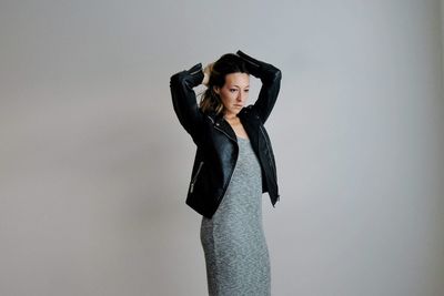 Young woman looking away against white background