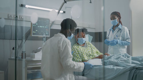 Doctors examining patient at hospital