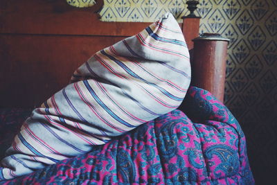 Close-up of pillow and blanket on bed at home