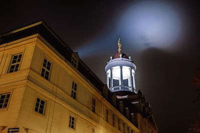 Low angle view of illuminated building against sky at night