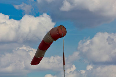 Low angle view of crane against cloudy sky