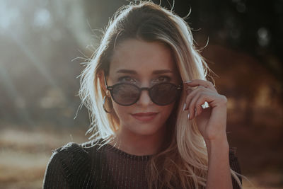 Portrait of young woman wearing sunglasses during sunny day