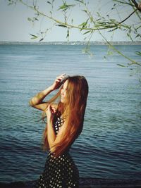 Woman standing on sandy beach