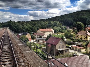 Railroad track against cloudy sky