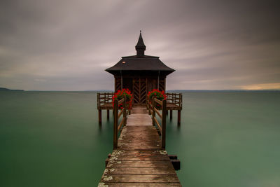 Pier over sea against sky