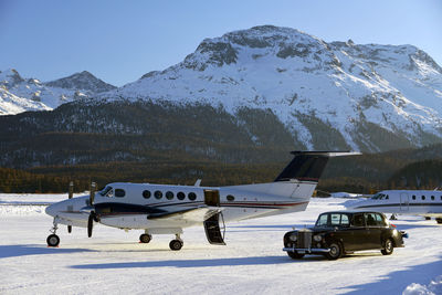A vintage car and private jets in the airport of engadine st moritz