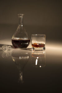 Close-up of wine glasses on table against black background