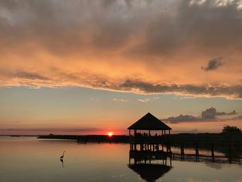 Scenic view of lake against orange sky