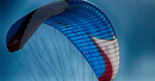 Low angle view of flag against blue sky