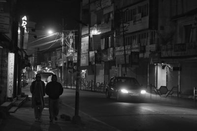 Illuminated city street at night
