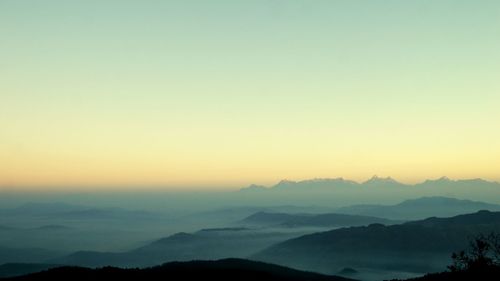 Scenic view of silhouette mountains against sky during sunset