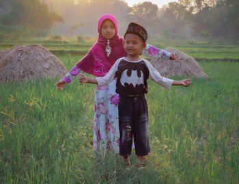 Full length portrait of boy standing on field